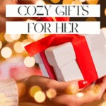 A person holds a white gift wrapped with a red ribbon. Text above the gift reads "Affordable Cozy Gifts for Her" in a festive setting with blurred golden lights, perfect for finding cool baking gadgets she'll love. Branding at the bottom says "The Bargain Sisters.