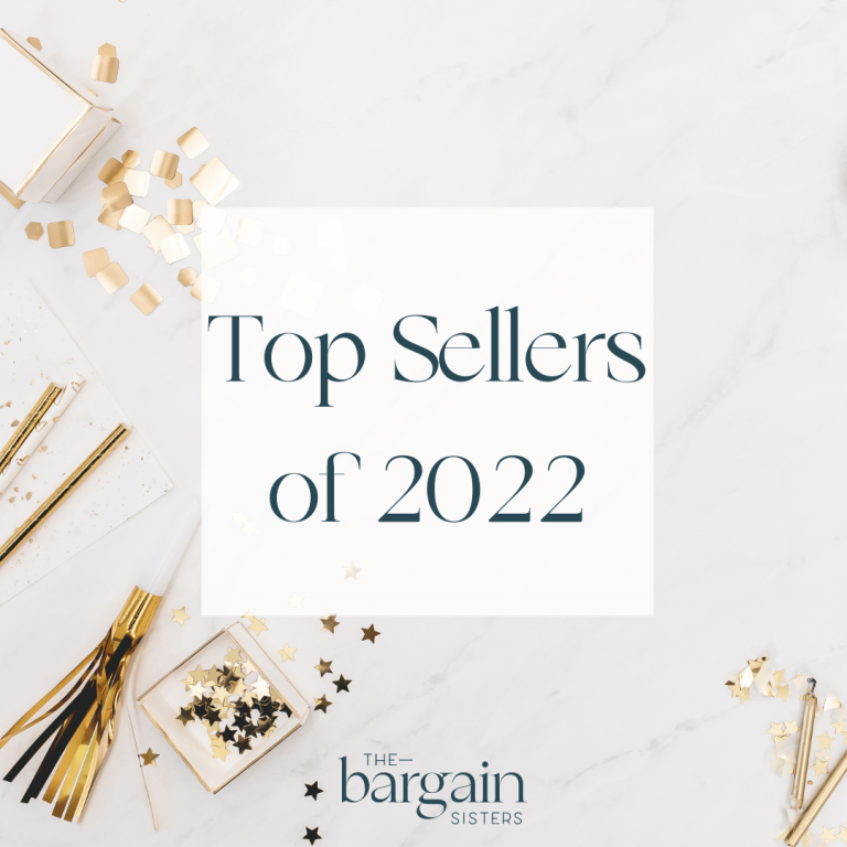 An elegant image features the text "Top Sellers of 2022" in a stylish font on a pristine white background. Surrounding the text are gold and black party decorations, including ribbons, stars, and confetti, with "The Bargain Sisters" logo at the bottom center.