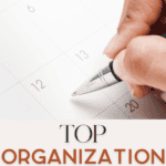 A hand holding a pen is poised above a calendar planner. The words "Top Organization Essentials for Families" are written below the image, with "The Bargain Sisters" in smaller text.