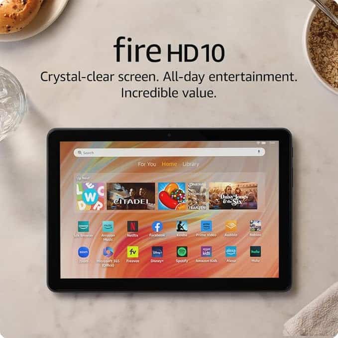 Tablet displaying apps with text above it: "Fire HD10. Crystal-clear screen. All-day entertainment. Incredible value." Snap up this must-have on a light surface next to a glass of water and cereal during our exclusive Wednesday Deals!