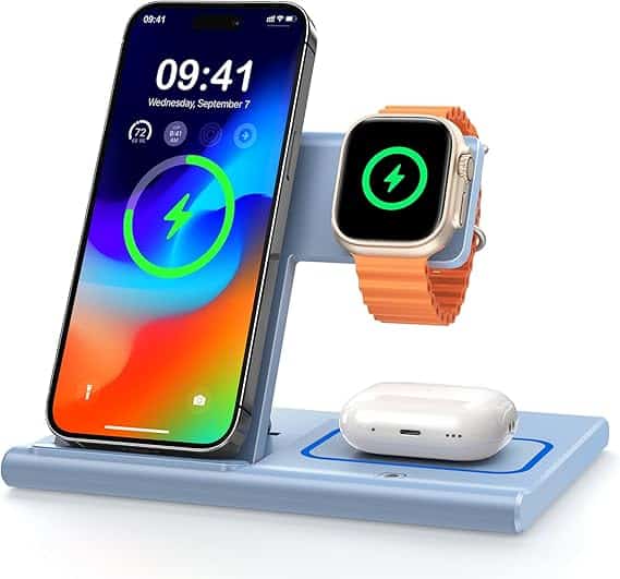 A modern, sleek charging station holds a smartphone with a vibrant screen, a smartwatch with an orange band displaying a charging icon, and wireless earbuds. This setup rests elegantly on a minimalist blue stand—a perfect find for those irresistible Monday Deals.