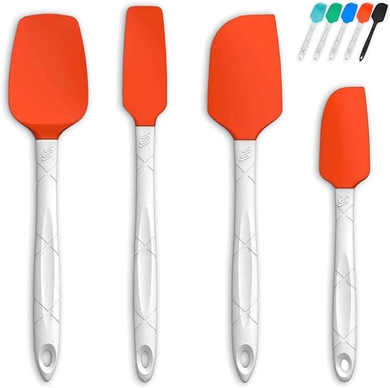 Set of silicone spatulas with white handles and orange heads. Includes four spatulas of different shapes and sizes, with small colored tops above in teal, black, and white. Perfect for your kitchen collection, they make a great addition to Monday Deals.