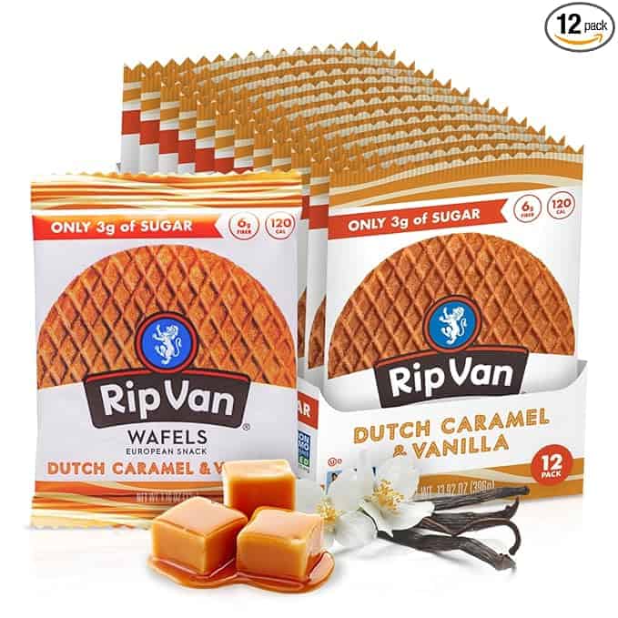 Image of Rip Van Dutch Caramel & Vanilla Stroopwafels packaging, perfect for your Monday Deals hunt. The pack highlights "Only 3g of Sugar" with a waffle image, caramel pieces, and vanilla flowers. The display showcases a 12-pack box of this classic European snack.