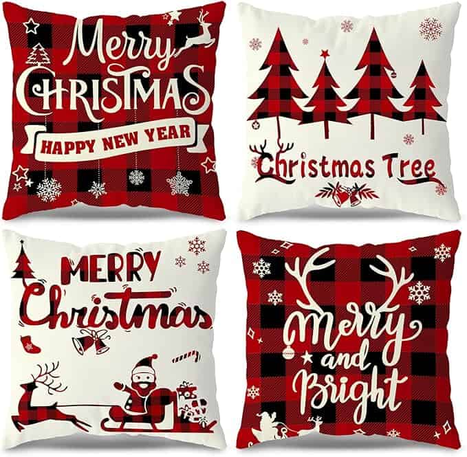 Four festive pillows with Christmas designs: "Merry Christmas Happy New Year" in plaid, red trees labeled "Christmas Tree," Santa with "Merry Christmas," and antlers with "Merry and Bright." Each features red, black, and white colors with winter motifs—perfect for Tuesday Deals!