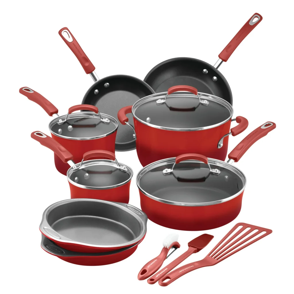 This vibrant red cookware set, featuring Tuesday Deals exclusives, includes two frying pans, three saucepans with lids, a Dutch oven with lid, a sauté pan with lid, a round cake pan, and kitchen utensils such as a spatula, whisk, spoon, and basting brush—all boasting stylish red handles.