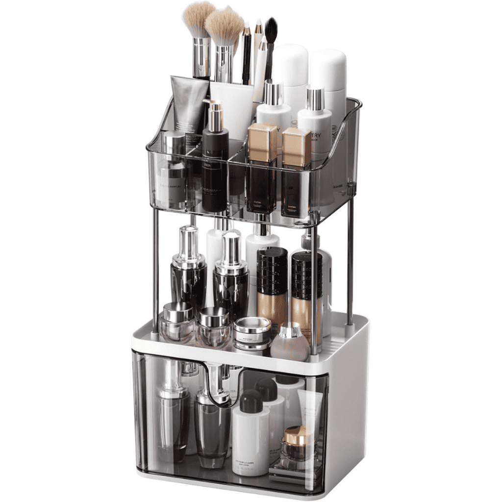 A neatly organized, multi-tiered storage rack holds various makeup brushes, bottles, and containers of skincare products. The transparent and sleek design showcases Tuesday Deals on a mix of lotions, creams, and makeup essentials.