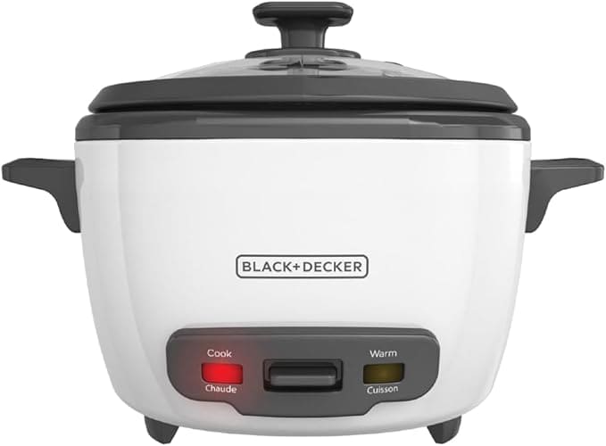 A black and white Black+Decker rice cooker, perfect for Friday Deals, features a lid, dual indicator lights labeled "Cook" and "Warm," and convenient side handles. The brand logo is prominently displayed on the front.