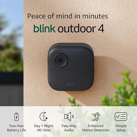 Image of a Blink Outdoor 4 security camera mounted on a wall. Text reads "Peace of mind in minutes" and highlights features: two-year battery life, day and night HD view, two-way audio, enhanced motion detection, and simple setup—perfect for those Friday Deals.