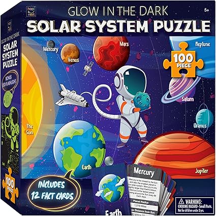 Explore the "Glow in the Dark Solar System Puzzle" box, showcasing an astronaut among planets like Earth, Saturn, and Neptune. With a colorful 100-piece puzzle and 12 fact cards, it's perfect for ages 5 and up. Don't miss out on this celestial adventure with our special Friday Deals!