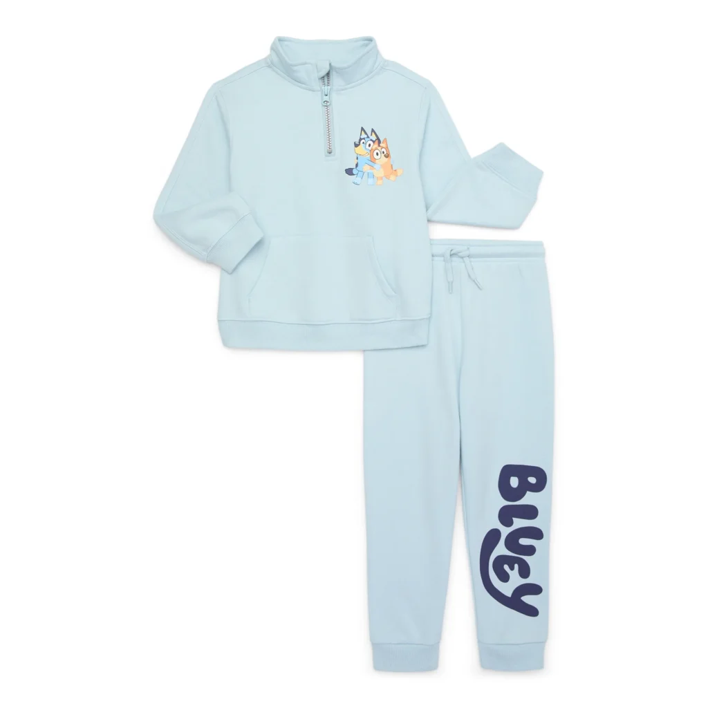 Light blue children's tracksuit featuring a half-zip sweatshirt with a cartoon dog graphic, paired with matching pants boasting "Bluey" in bold on the leg. Perfect for little fans, this set is part of our fantastic Friday Deals!