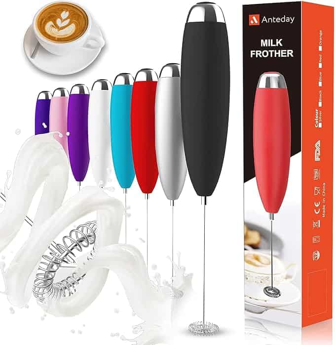 A colorful set of handheld milk frothers with various handles, perfect for crafting that Monday Deals latte foam art. The frothers, surrounded by playful splashes of milk, come in a boxed version on the right. A beautifully frothed cup sits in the top left corner, ready to elevate your coffee ritual.