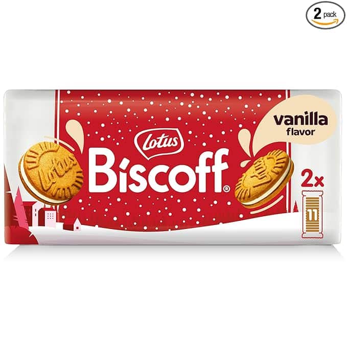 The packaging of Lotus Biscoff vanilla-flavored cookies showcases a festive design in red and white with snow accents, featuring two cookie images. Perfect for those Tuesday Deals, it's labeled as a 2-pack, doubling the deliciousness shown on the package.