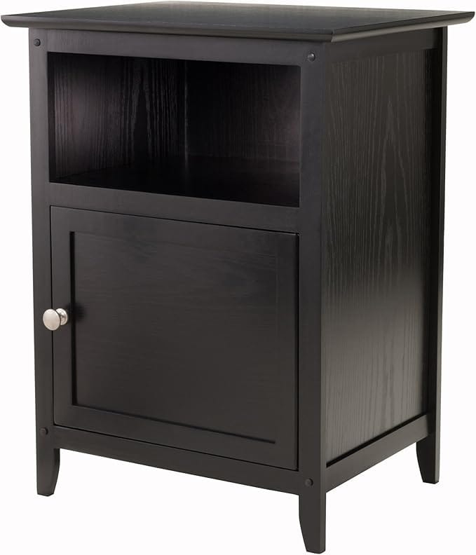 Discover our Thursday Deals featuring a sleek black wooden nightstand. It boasts a small open shelf on top and a closed cabinet door with a round silver handle below. With its simple rectangular lines and sturdy four-leg design, this piece adds elegance to any room.