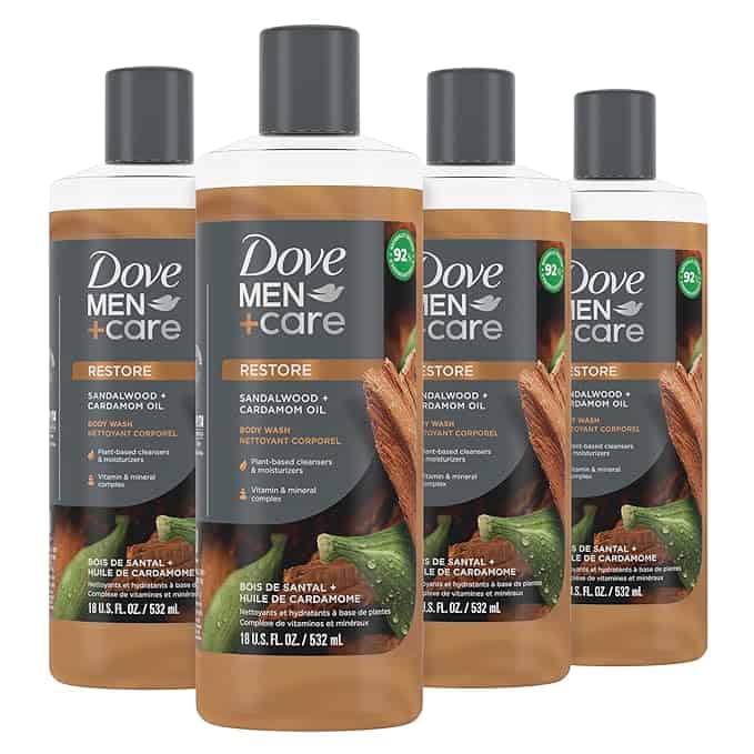 Four bottles of Dove Men+Care Restore body wash with sandalwood and cardamom oil, sporting dark caps and a label highlighting 92% naturally derived ingredients. Each 18 fl oz (532 ml) bottle could enhance your grooming routine. Don't miss out on these Friday Deals!.