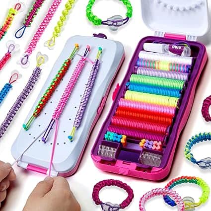 A colorful lanyard-making kit with various neon and pastel strings, tools, and example bracelets. Two hands are actively weaving a bracelet using the kit, a perfect find for Tuesday Deals seekers looking to spark creativity.