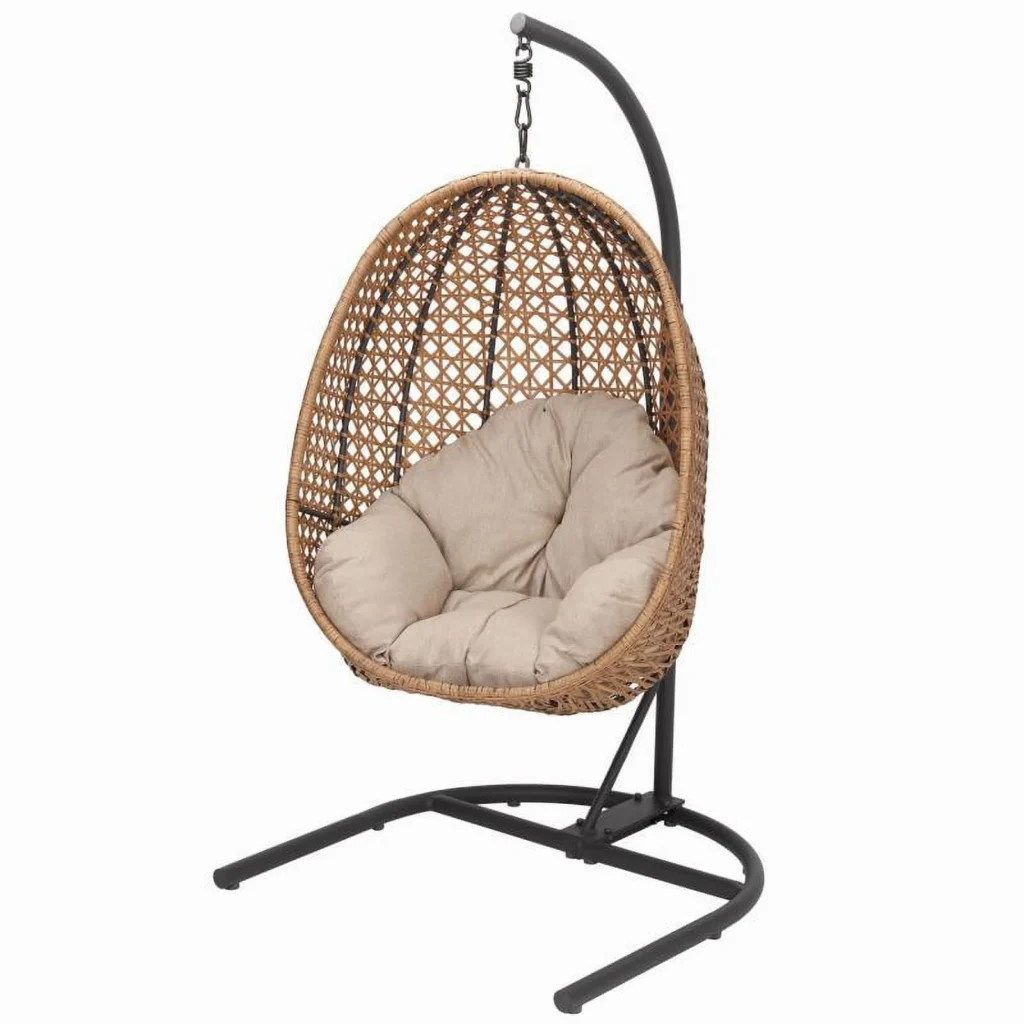 A hanging rattan egg chair with a beige cushioned seat, supported by a curved black metal stand, features an open lattice design against a plain white background. Discover this stylish piece among our exclusive Wednesday Deals.