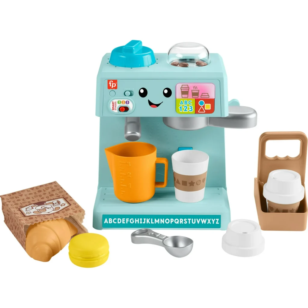 This colorful toy coffee machine, complete with a smiling face, buttons, and knobs, is surrounded by a toy croissant, coffee cup, milk carton, and scoop. With alphabet letters on its base, it offers endless fun—perfect for those Monday Deals.