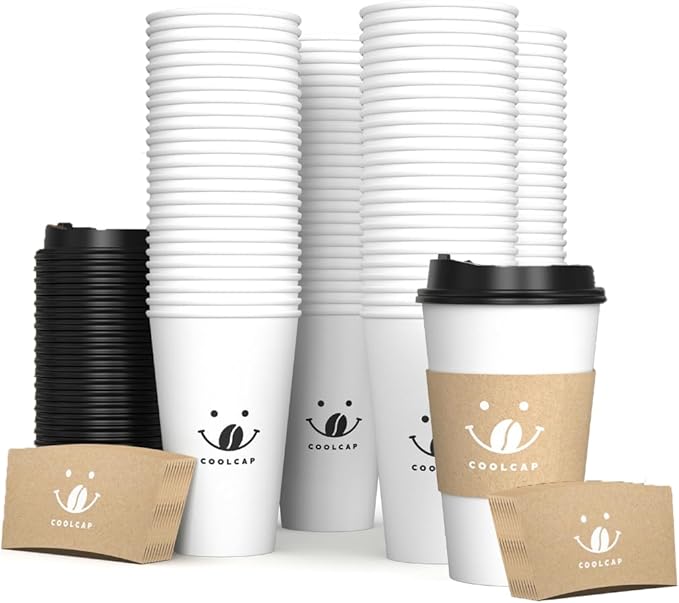 A large stack of white disposable coffee cups with black lids and cardboard sleeves awaits, showcasing a smiley face logo and the word "COOLCAP." Several sleeves are neatly arranged in front, perfect for enjoying those Monday Deals.