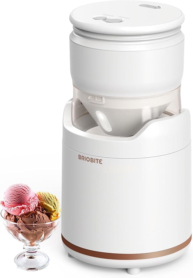 A white ice cream maker stands next to a glass dish with three scoops of ice cream in vibrant pink, rich brown, and refreshing green. Featuring a sleek design with "BRIOBITE" on the front, it's the perfect addition for indulging in your favorite flavors during Friday Deals.