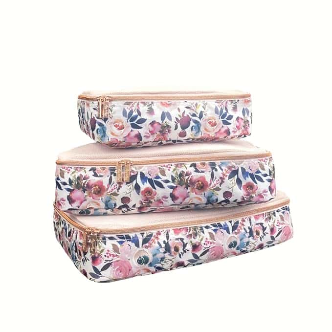 Stacked against a white backdrop, three floral-patterned packing cubes in varying sizes feature zipper closures and vibrant pink, blue, and green flower designs on a light background. Perfect for organizing essentials or snagging during Friday Deals for an unbeatable bargain.