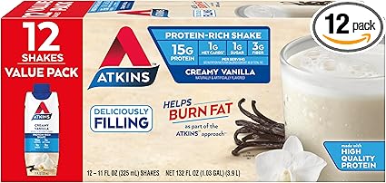 Box of Atkins Creamy Vanilla Protein-Rich Shakes, featured in Tuesday Deals, is a 12-pack value pack. Each shake offers 15g protein, 1g sugar, 1g net carbs, and 3g fiber. Deliciously filling and helps burn fat, it comes with a vanilla pod-adorned glass image.