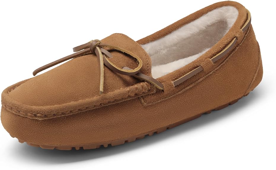 A single brown suede moccasin-style slipper featuring a bow on top, perfect for lounging during Friday Deals. The interior is lined with light-colored fur for added warmth and comfort, while the textured sole ensures a firm grip.