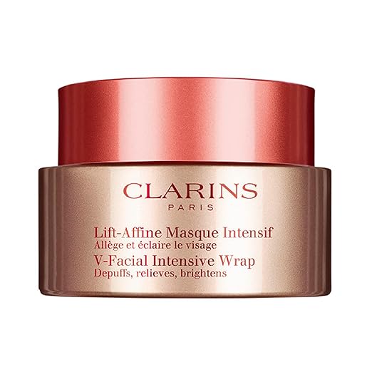 A jar of Clarins Paris V-Facial Intensive Wrap with a bronze and copper design awaits your skincare routine. Labelled "Lift-Affine Masque Intensif: Dépuffs, relieves, brightens," it's the perfect treat—especially during Monday Deals!.