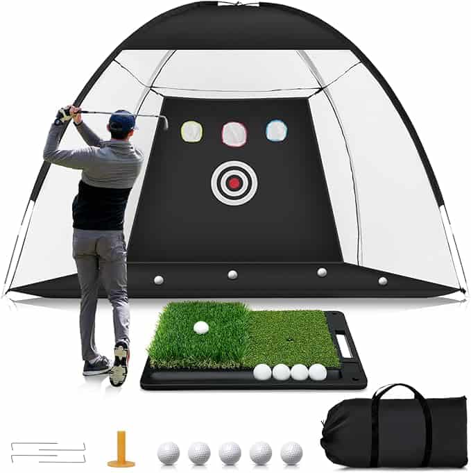 A person swings a golf club towards a large golf practice net with target circles, snagged as part of Tuesday Deals. The set includes a hitting mat, several golf balls, a tee, and a carrying bag, all neatly arranged in front of the net.