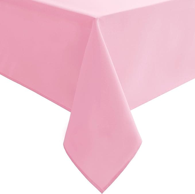 A close-up of a pink tablecloth draping over the corner of a table shows its smooth fabric texture and pointed edge, perfect for highlighting this week's Wednesday Deals.