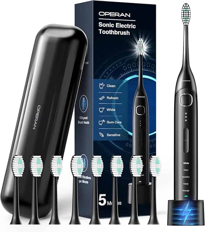 Displayed is a black electric toothbrush set with six extra brush heads, perfect for those seeking Monday Deals. It includes a travel case and charging base, with features like cleaning modes tailored to "White," "Clean," and "Sensitive" needs.