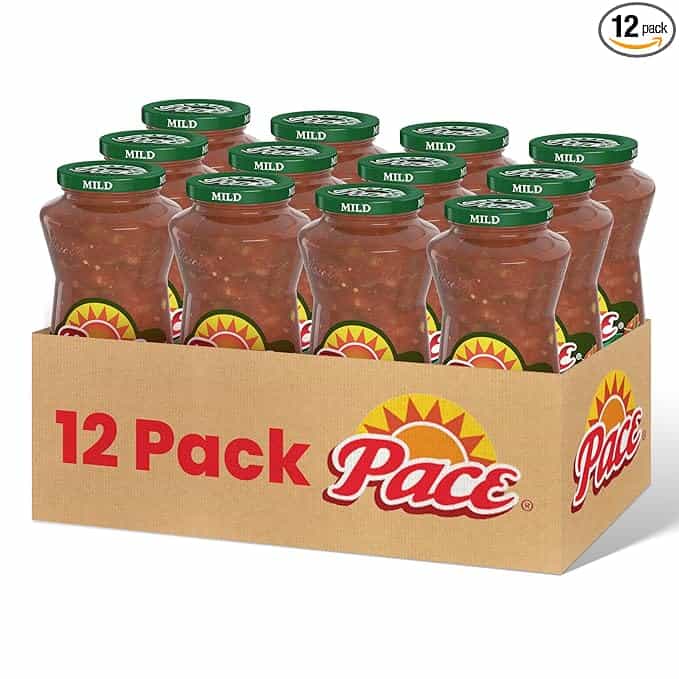 The "12 Pack" cardboard box, labeled with the Pace logo and a vibrant yellow sun design, holds twelve jars of Mild salsa, each adorned with a green lid. Perfect for snacking during those Friday Deals shopping sprees!.