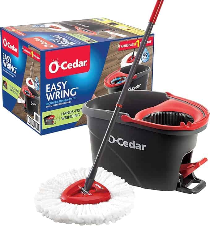 Box and assembled O-Cedar EasyWring microfiber spin mop and bucket system. Perfect for Tuesday Deals, the mop features a white microfiber head, and the black and red bucket includes a built-in wringer. Packaging is prominently displayed in the background.