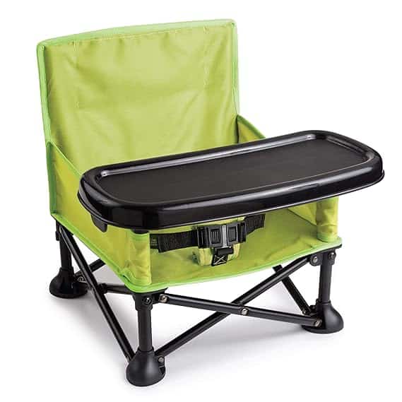 This portable green baby booster seat, available now in our Wednesday Deals, includes a black safety harness and detachable tray. Its foldable design with sturdy legs ensures easy transportation and storage.