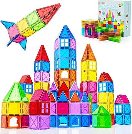 Colorful magnetic tiles in various shapes are assembled into a tower and rocket. A box with tiles is shown in the background, featuring bright translucent colors like red, blue, green, and yellow—perfect for exploring creativity during Friday Deals.