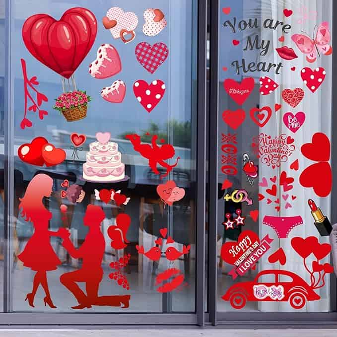 Celebrate Valentine's Day with our lively window decals featuring red and pink hearts, a couple in love, a hot air balloon, cake, teddy bears, and joyous phrases. These vibrant designs are perfect for setting the mood—and don't miss our special Monday Deals!.