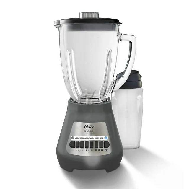 A black and silver Oster blender with a transparent pitcher, perfect for Wednesday Deals shopping. It includes an additional blending jar and features a control panel with multiple buttons for various blending settings. The blending jar comes with a sleek black lid.