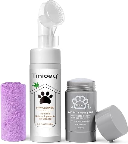 A bottle of no-rinse paw cleaner with a brush cap, a stick of paw pad and nose balm, and a rolled purple towel are neatly displayed. These "Tinioey" items feature adorable paw print designs. Grab them now as part of our special Friday Deals!.