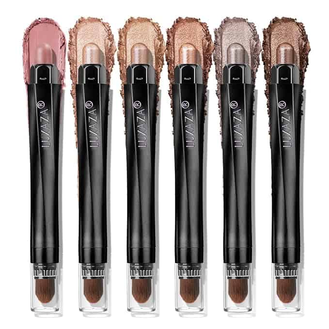 Six black makeup sticks from LUXAZA, each with attached brushes and topped with metallic shades from pink to brown. Perfect for a stunning look, especially while taking advantage of our exclusive Friday Deals.