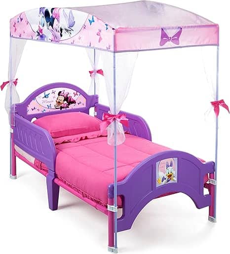 Experience Monday Deals with this charming purple and pink children's canopy bed! Featuring Disney characters and a delightful Minnie Mouse theme, the bed comes complete with a pink comforter. The canopy is adorned with bows, butterflies, and playful illustrations of Minnie Mouse.