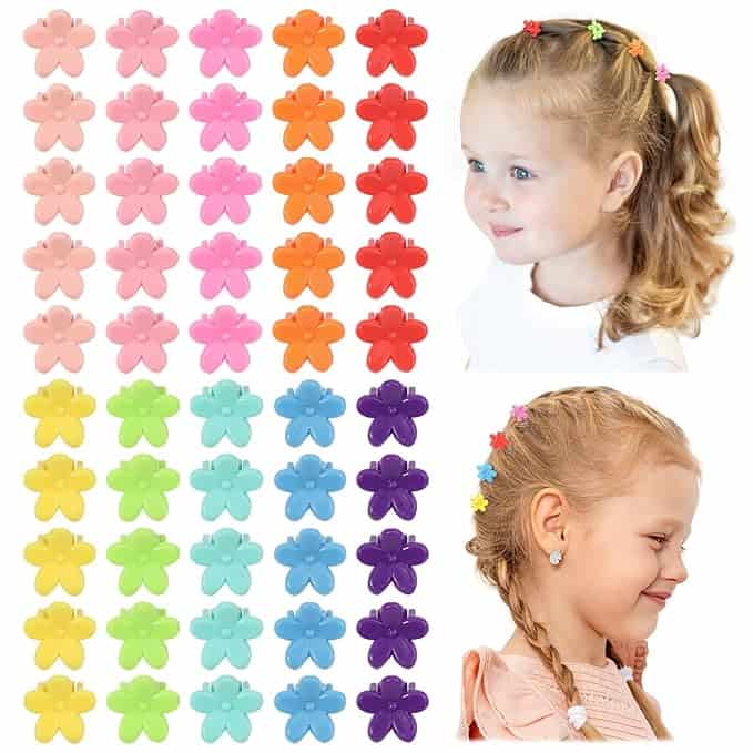 A set of colorful butterfly hair clips in vibrant shades, including pink, red, orange, yellow, green, blue, and purple. Snag yours with our exclusive Monday Deals. Two young girls wear the clips in their curls and braids.