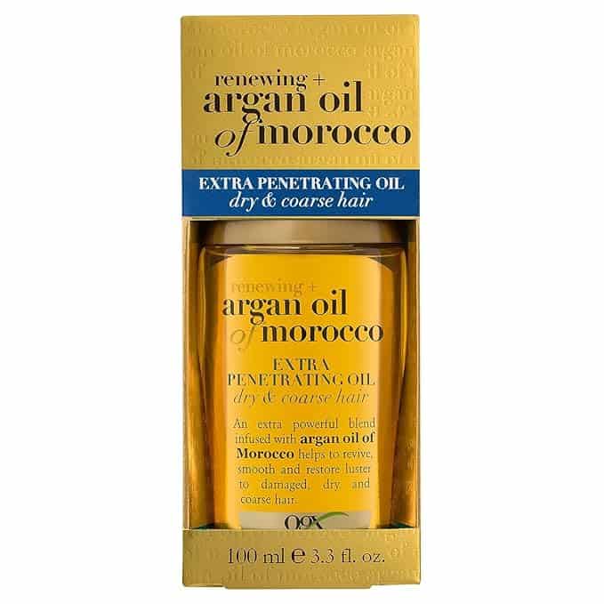 A yellow and blue box of "Renewing Argan Oil of Morocco" for dry and coarse hair, offers a Thursday Deals special. It includes a 100 ml bottle of OGX's extra penetrating oil, perfect for restoring luster to damaged hair.