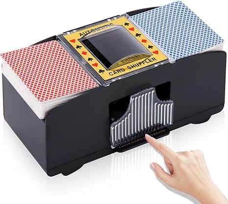 A hand hovers over a button on an automatic card shuffler, ready to mix two decks of cards—one red and one blue—like a perfect shuffle on Tuesday Deals.