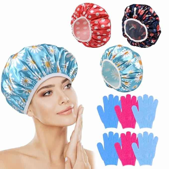 A woman wearing a blue shower cap with daisy patterns touches her face. Surrounding her are three more caps in red polka dot, black floral, and another blue daisy design. Below are exfoliating gloves in pink and blue, perfect for grabbing during Tuesday Deals!.