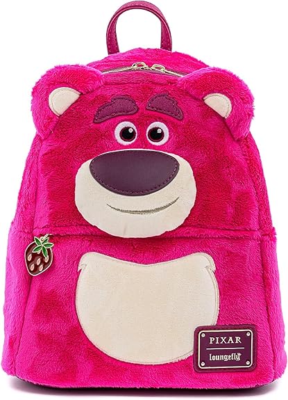 This whimsical pink plush backpack, shaped like a bear's face, boasts a fuzzy texture and embroidered details. It features a strawberry charm on the zipper and proudly displays the "Pixar Loungefly" logo at the bottom—perfect for snagging during our Wednesday Deals!.