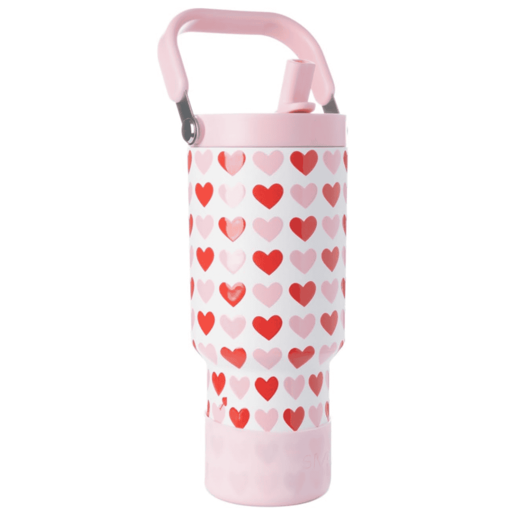 A tall, insulated water bottle featuring a pink handle and straw awaits your hydration needs. Adorned with alternating red and pink heart patterns, this stylish accessory is ready to accompany you wherever you go. Keep an eye on Friday Deals for a chance to snag this charming bottle!.